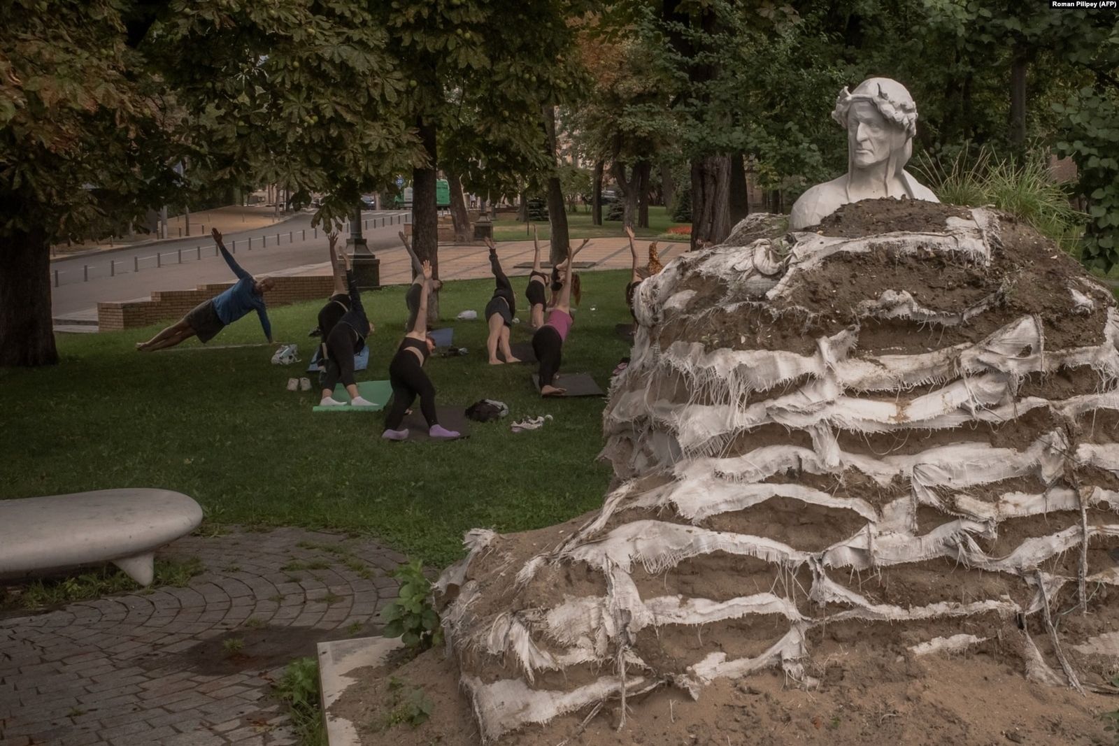 В Киеве люди занимаются спортом возле памятника итальянскому поэту Данте Алигьери, обложенного мешками с песком, чтобы защитить его от российских авиаударов. 8 сентября / Roman Pilipey / AFP / Radio Liberty