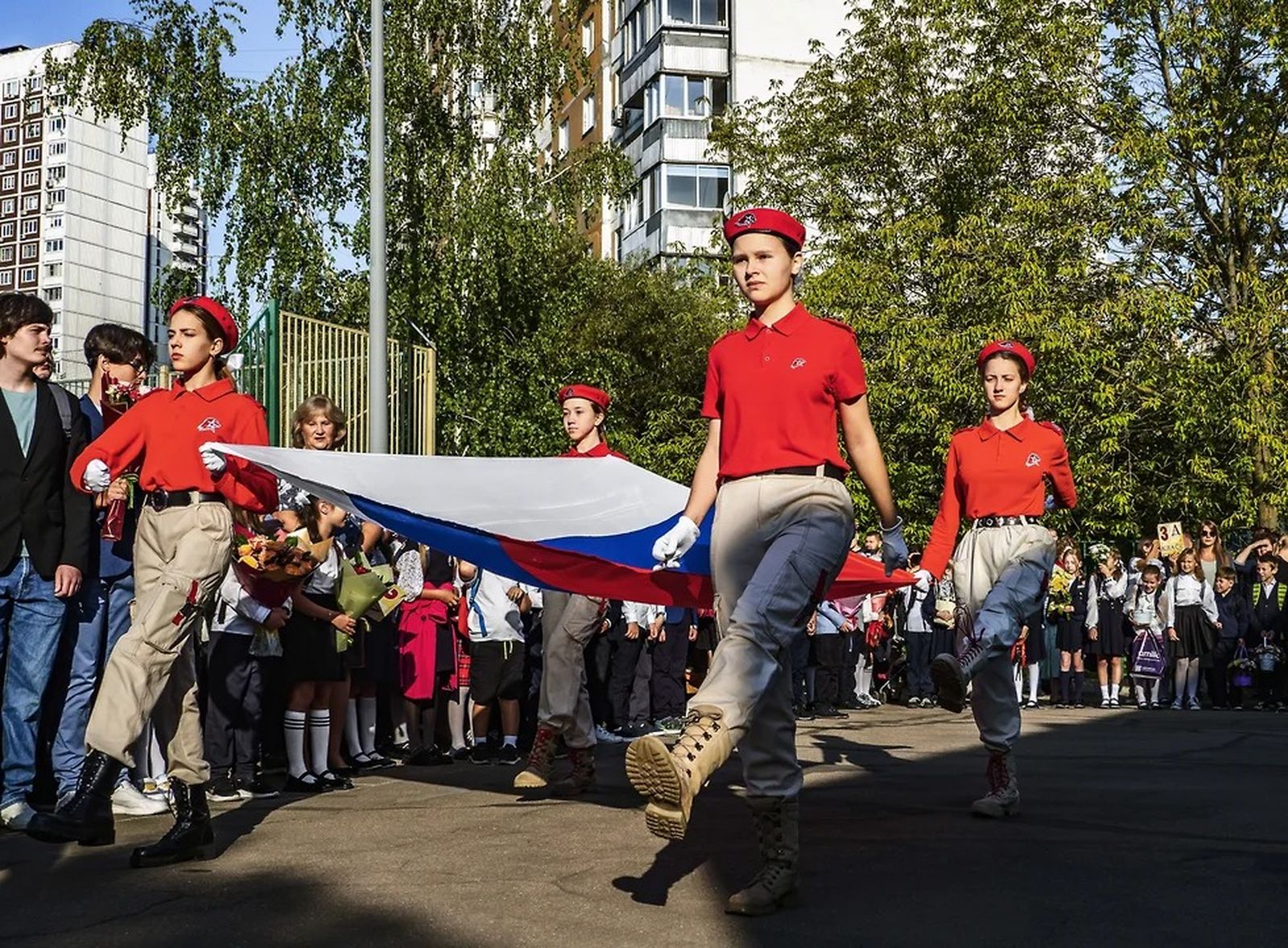 Ученицы московской школы №1741 выносят государственный флаг России. В новом учебном году в российских школах возвращаются курсы начальной военной подготовки, старшеклассников будут учить по новому учебнику истории, где рассказывается о «целях СВО» и 